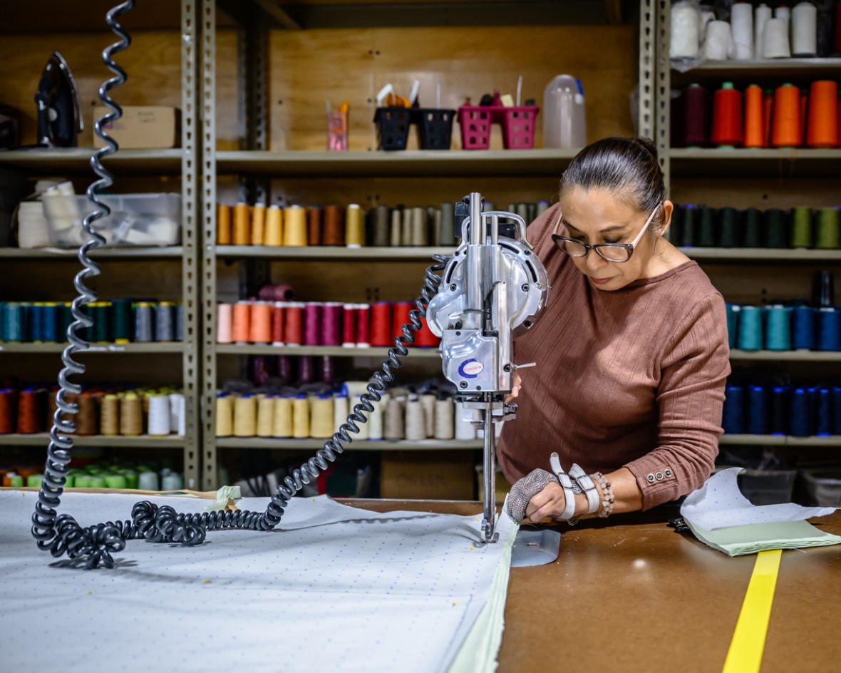Woman working a machine in a SCC textile factory