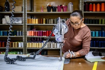 Woman working a machine in a SCC textile factory