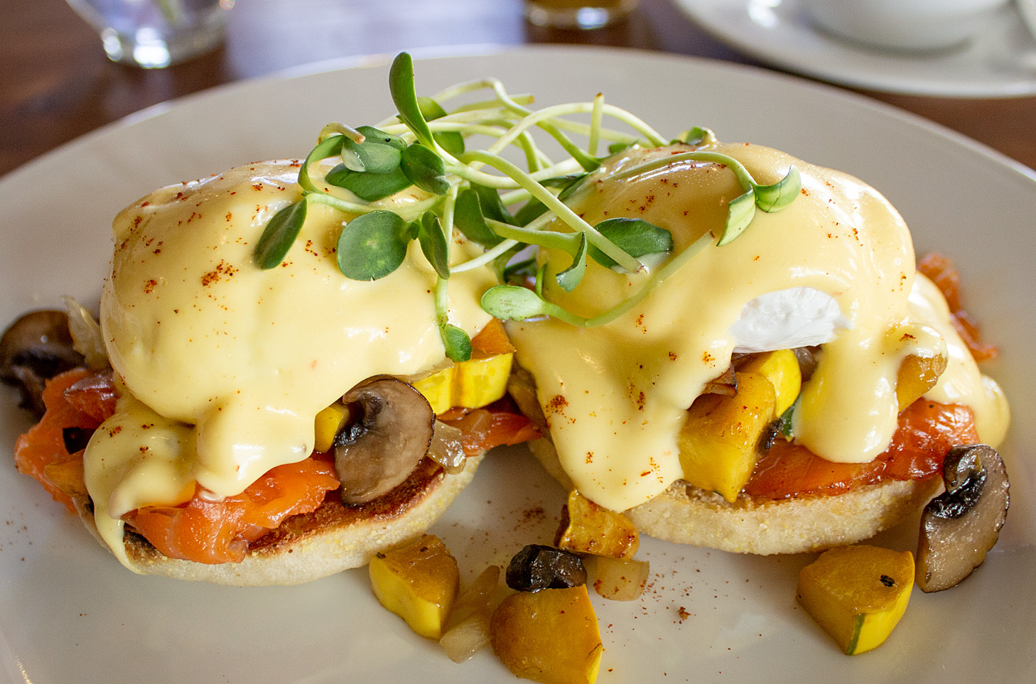 beet hummus with crostini in a black ceramic bowl